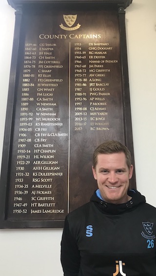 Ben Brown in front of the captain's board