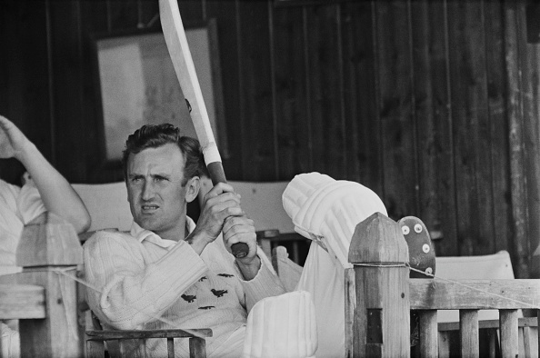 Ted Dexter seated on the veranda of a pavilion during a County Championship match between Sussex and Kent on 16th June 1964