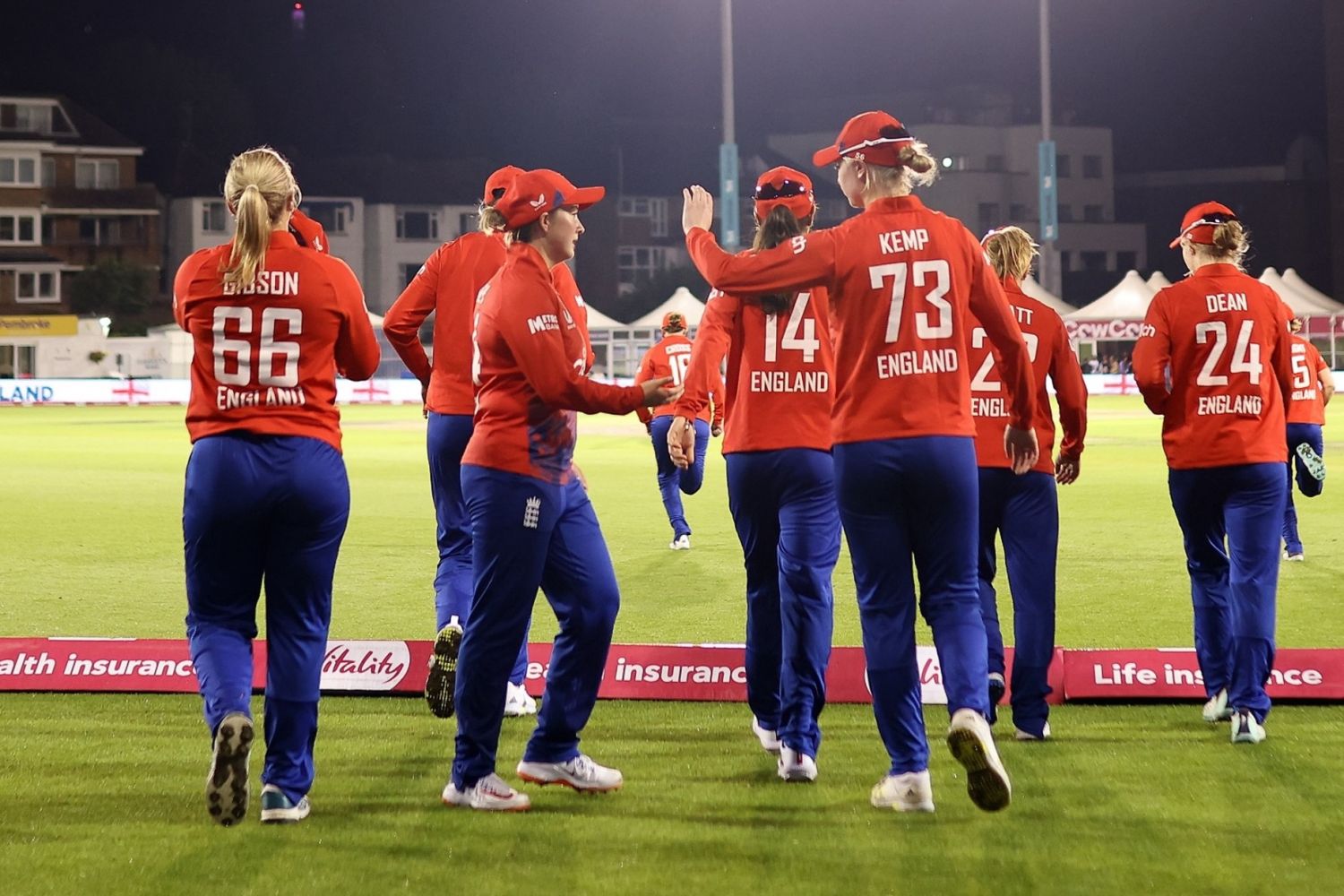 ngland women walking on the pitch