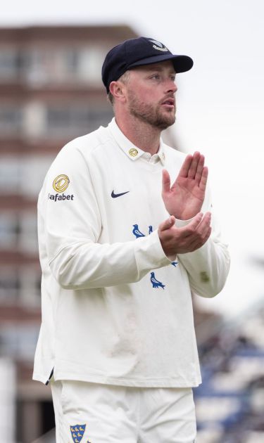 Ollie Robinson applauds as he walks off the field.