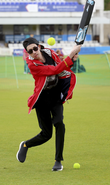 Participant at discoverability Day 2026 hits a ball
