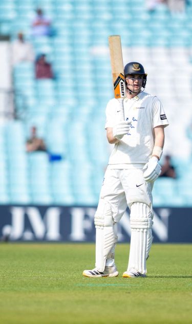 Jack Carson raises the bat as he goes past 50