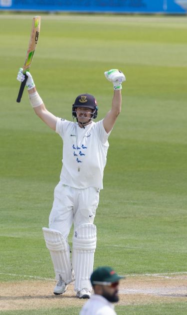 Daniel Hughes celebrates his century.