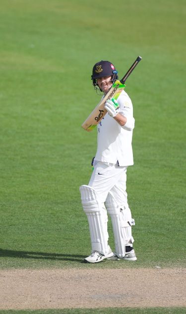 Dan Hughes raises the bat