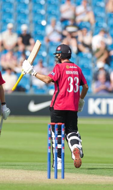Fynn Hudson-Prentice raises his bat for his 50.