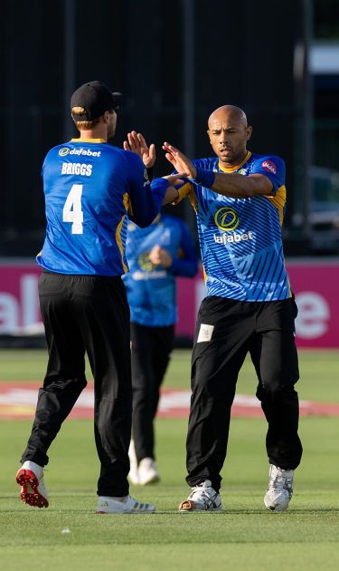 Tymal Mills celebrates with Danny Briggs