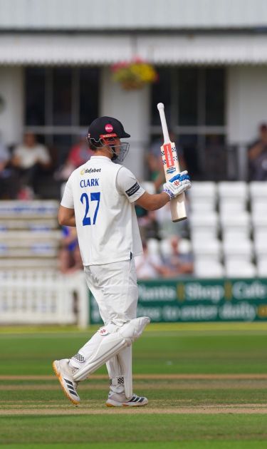 Tom Clark raises his bat for his fifty.