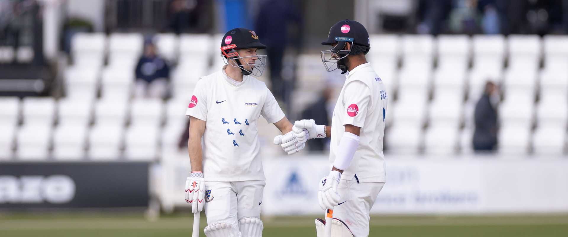 John Simpson and Cheteshwar Pujara touch gloves at Hove