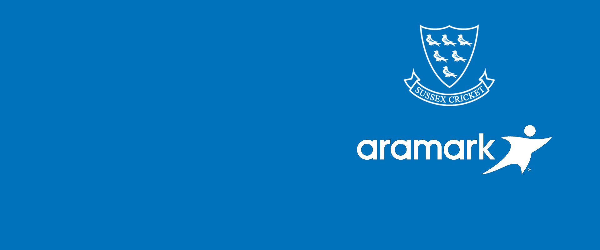 Sussex cricket logo on a blue background with Aramark, our new food provider's logo