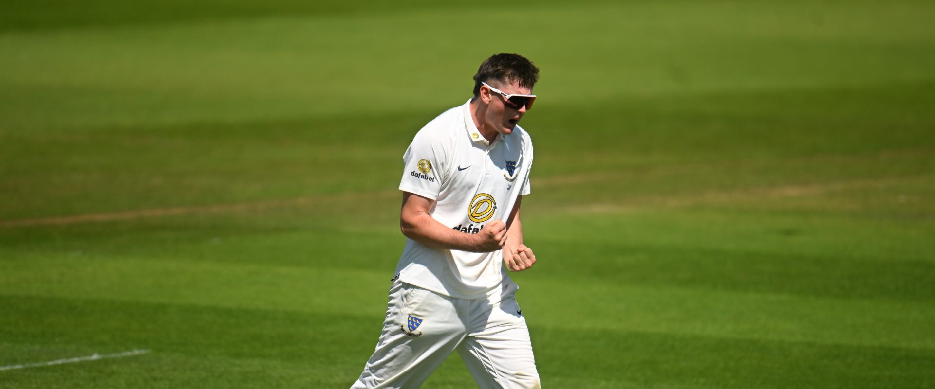 Jack Carson celebrates a wicket.