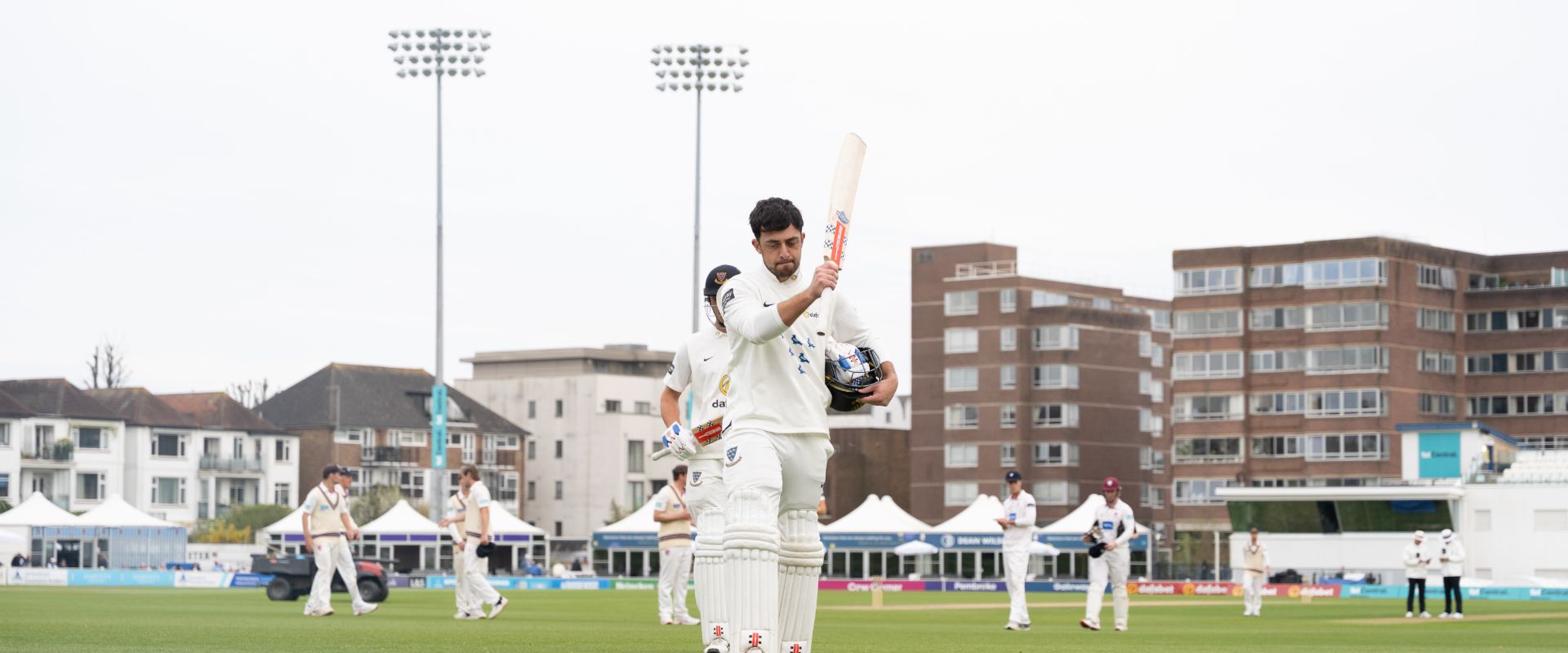 Tom Haines raises his bat after scoring a century against Somerset 