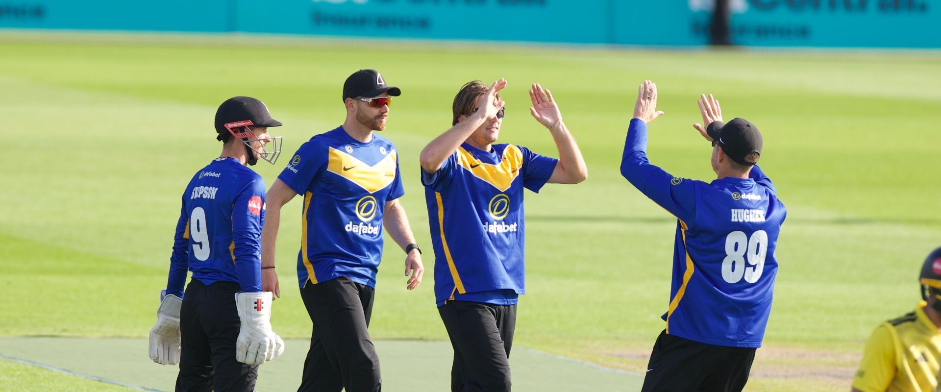 Sussex players celebrate a wicket with James Coles.
