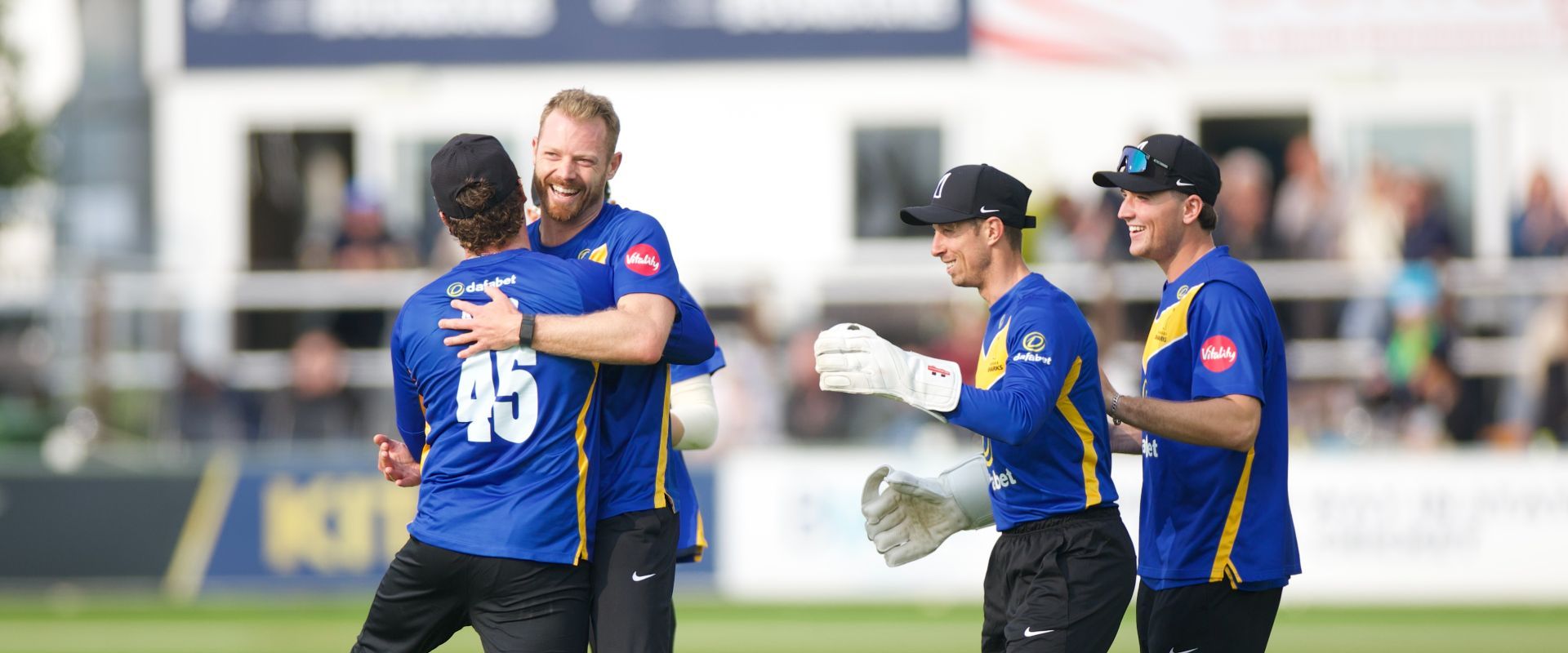 Sussex players celebrate with Nathan McAndrew after he took his fifth wicket.