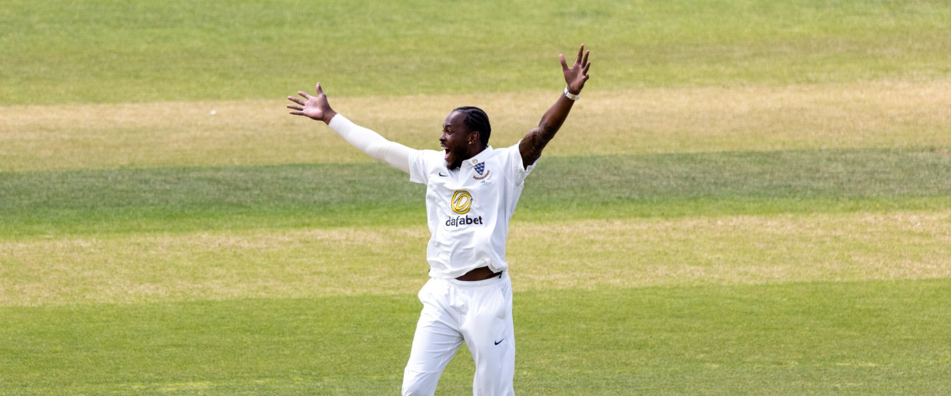 Jofra Archer appeals for a wicket while playing for Sussex.