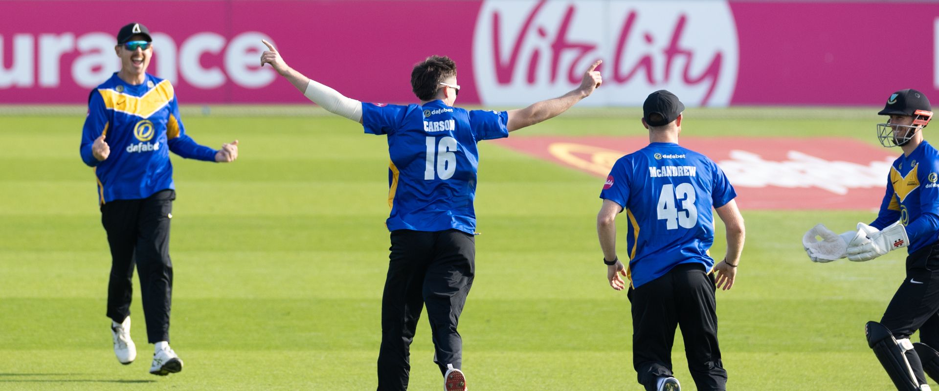 Jack Carson celebrates with teammates after taking a wicket in the match against Gloucestershire on Sunday