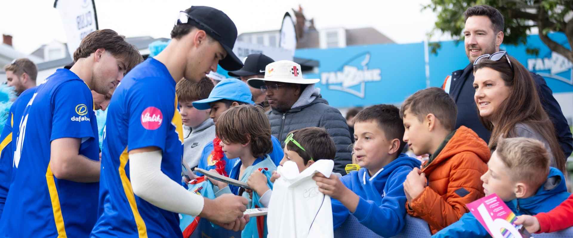 Tom Clark signs shirts for Sharks fans