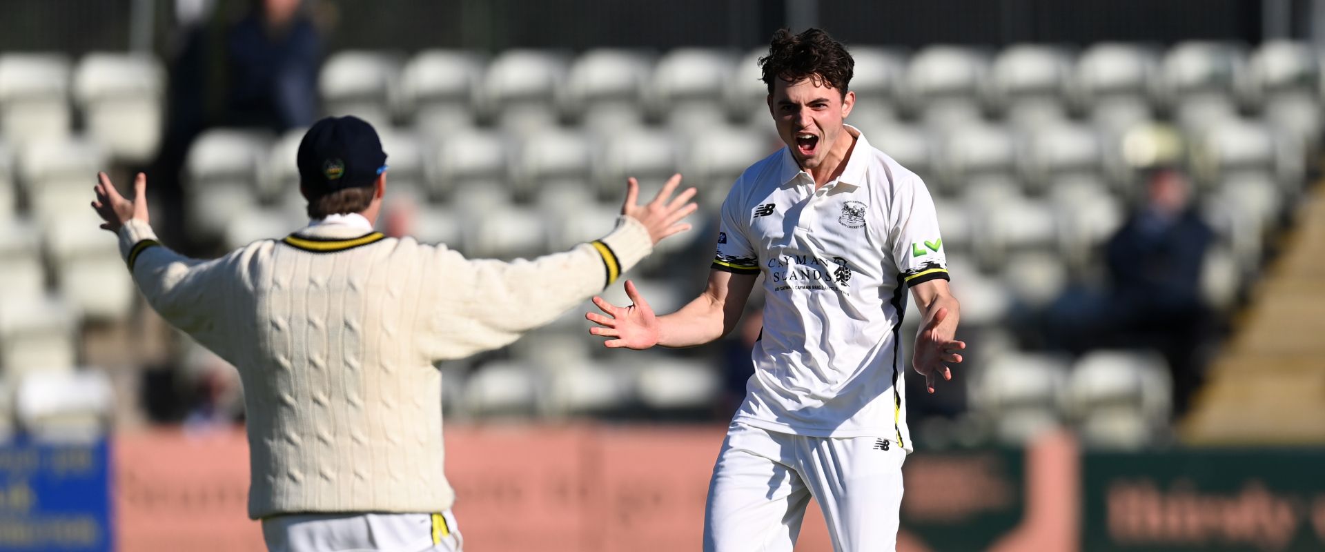 Tom Price in action after taking a wicket for Gloucestershire