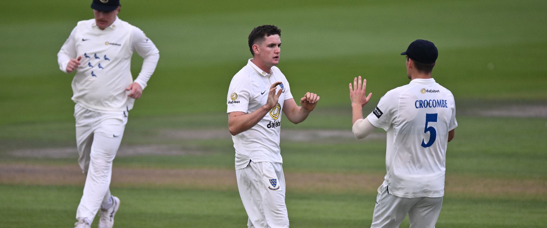 Jack Carson celebrates a wicket with Henry Crocombe.