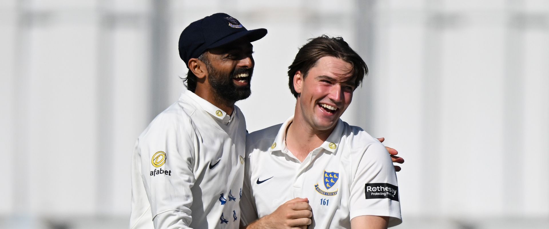 Jaydev Unadkat and James Coles celebrate together.