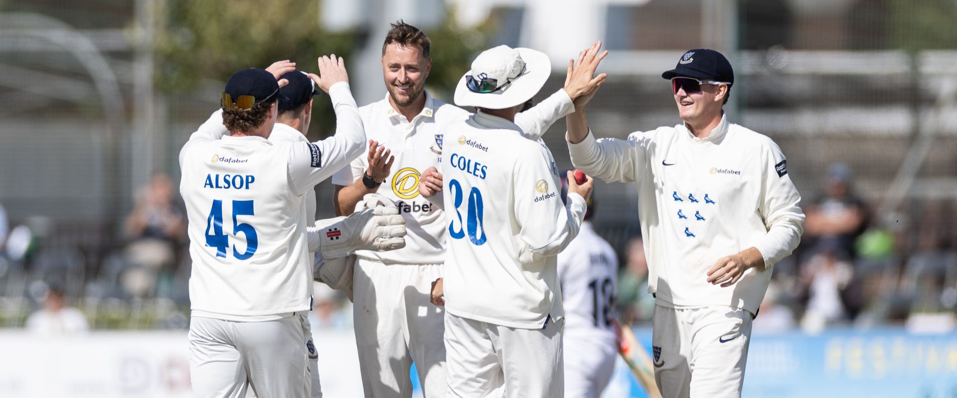 Sussex players celebrate after taking a wicket on Day 1