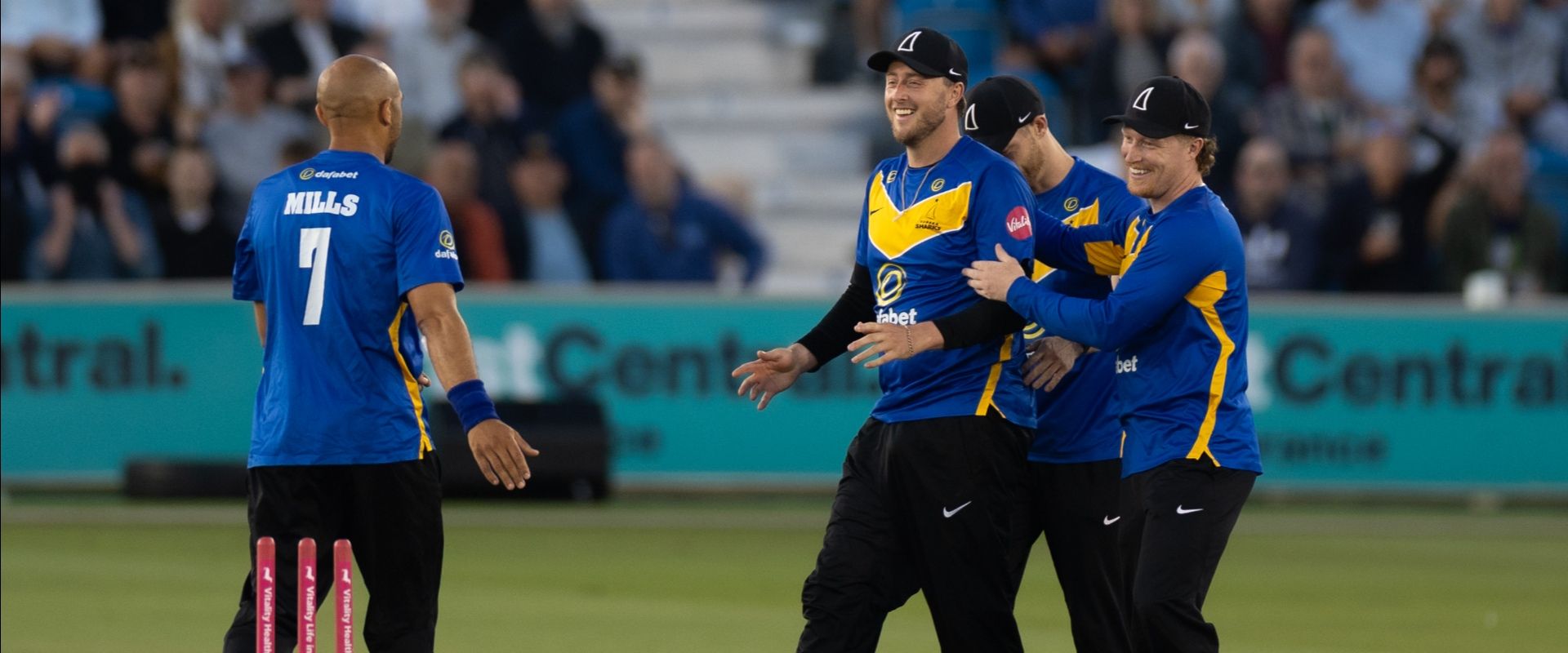 tymal mills and ollie robinson celebrate a t20 wicket at hove