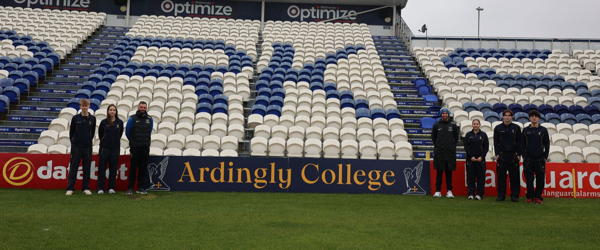 Pupils from Ardingly pose in front of the new advertising board with Sussex players at Hove