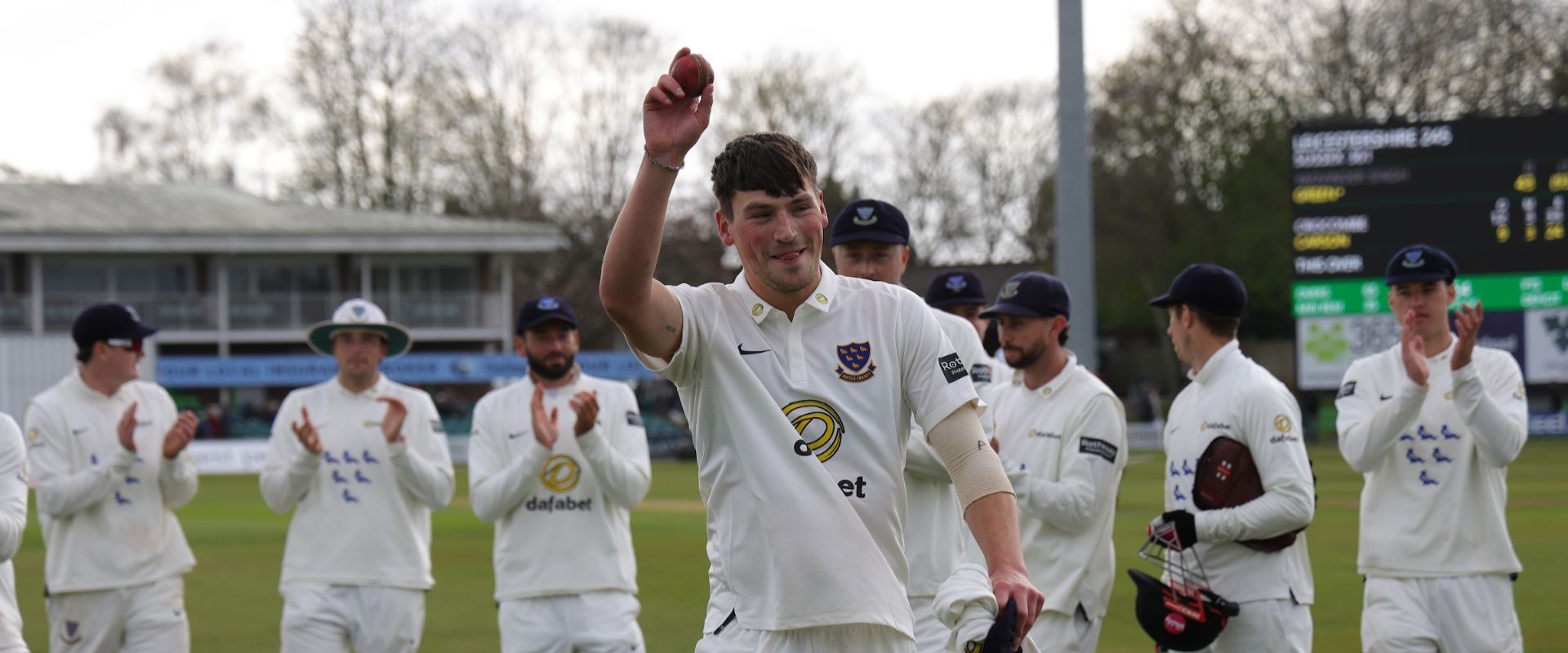 Crocombe raises the ball, acknowledging the applause for his five-fer.