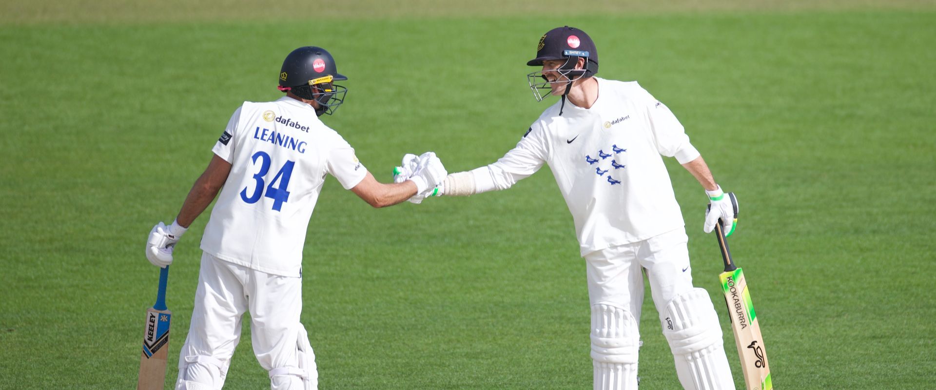 Leaning shakes hands with Hughes