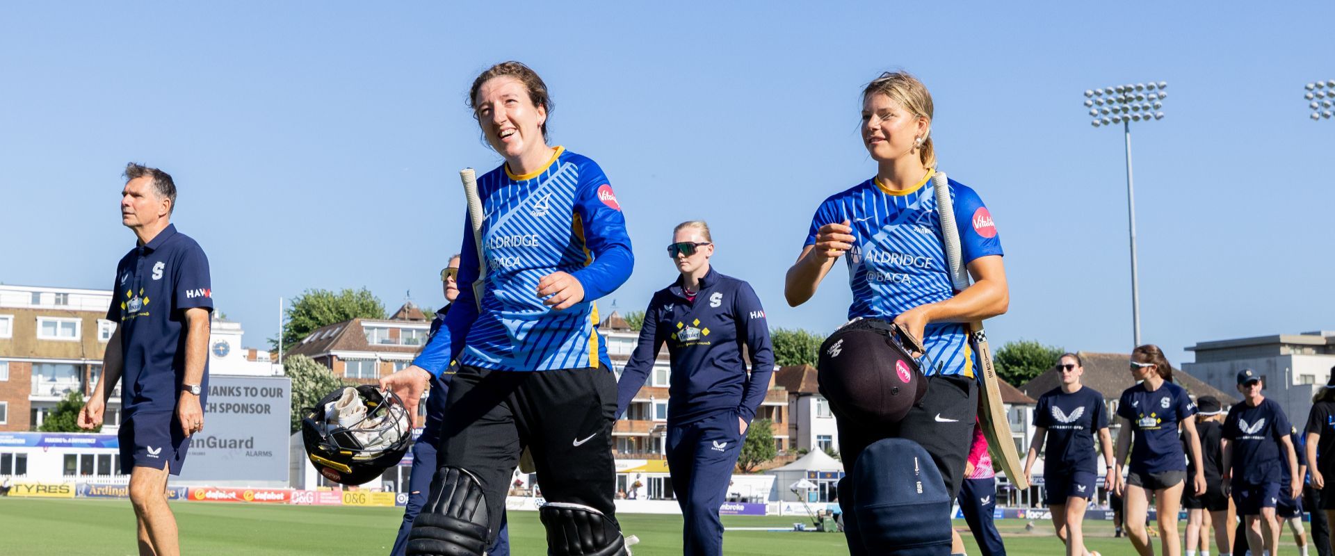Phoebe Wilkinson and Bella Johnson walking off the field after victory against Northants Steelbacks.