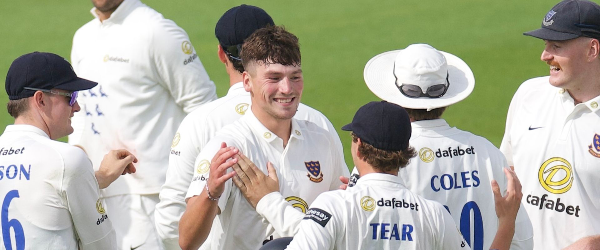 Henry Crocombe celebrates his five-fer with his teammates.