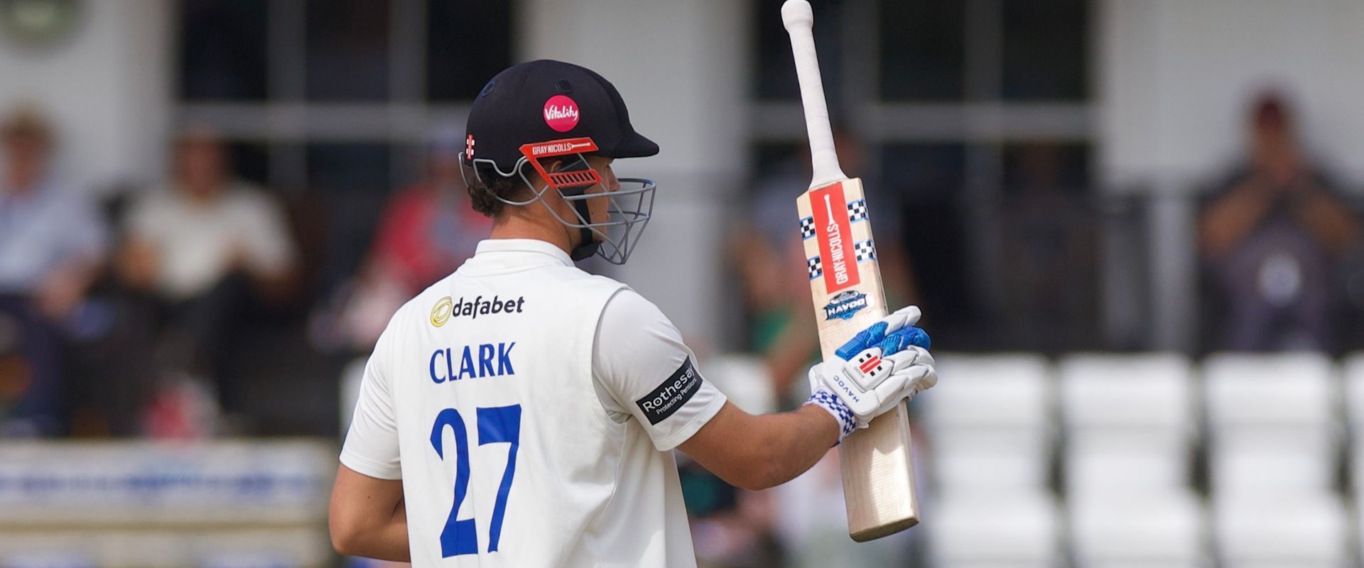 Tom Clark raises his bat for his fifty.