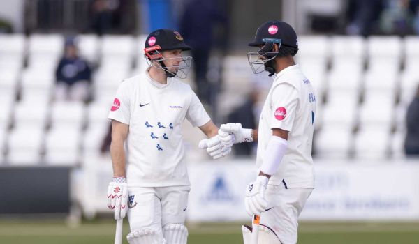 John Simpson and Cheteshwar Pujara touch gloves at Hove