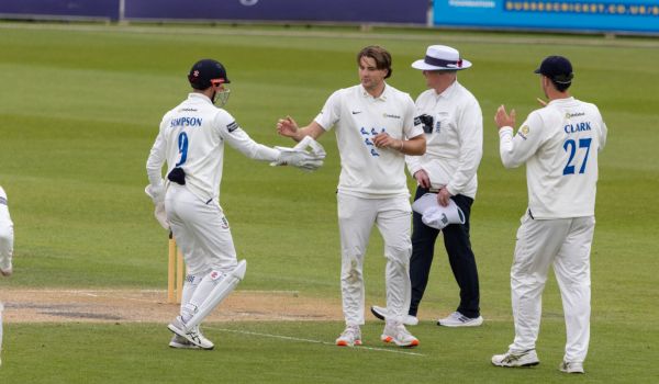 Sussex players celebrate after James Coles picks up a wicket on Day Three