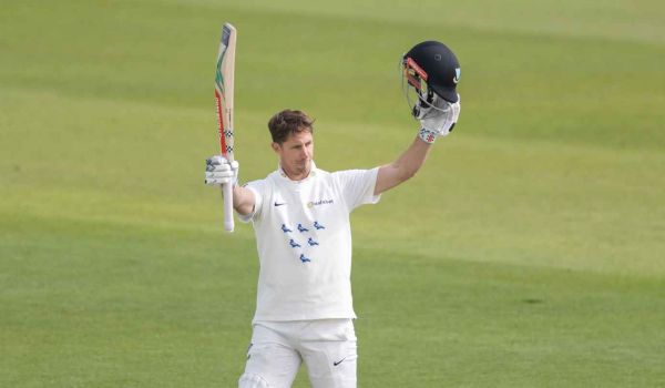 John Simpson raises his bat after another century for Sussex