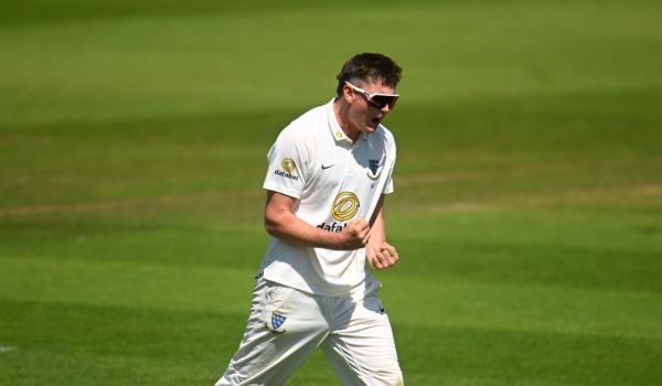 Jack Carson celebrates a wicket.