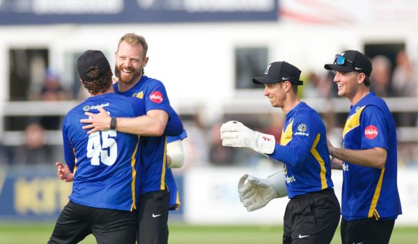 Sussex players celebrate with Nathan McAndrew after he took his fifth wicket.