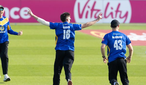 Jack Carson celebrates with teammates after taking a wicket in the match against Gloucestershire on Sunday