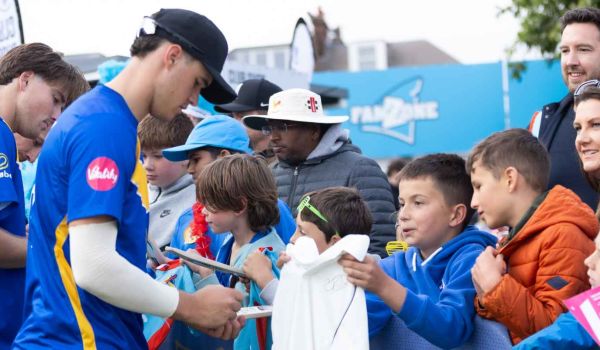 Tom Clark signs shirts for Sharks fans