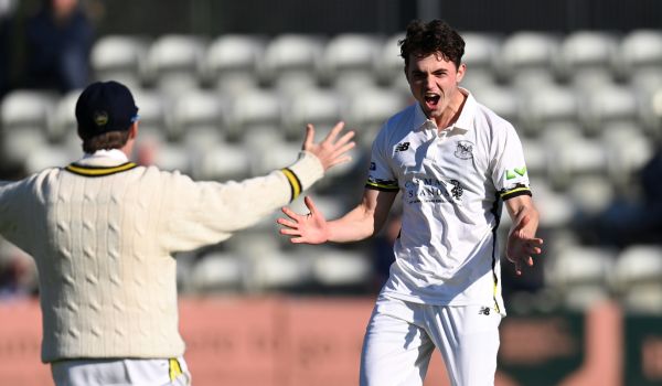 Tom Price in action after taking a wicket for Gloucestershire