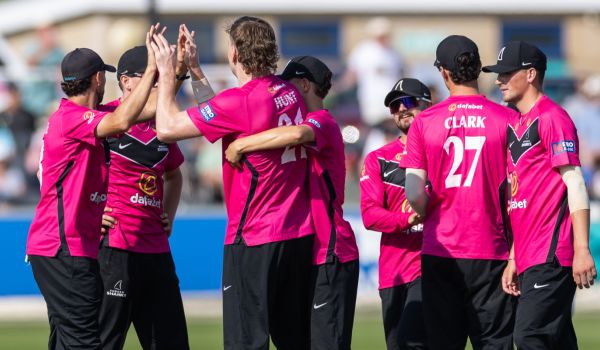 Sussex players celebrate after taking a wicket against Lancashire