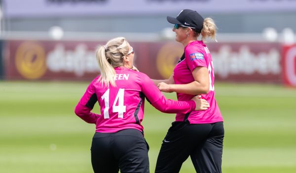 Chiara Green and Indigo Gentry celebrate after taking a wicket