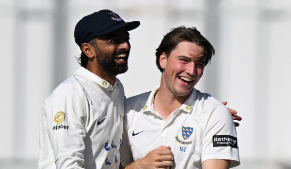 Jaydev Unadkat and James Coles celebrate together.