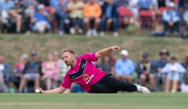 Danny Lamb fielding in front of a packed crowd at Arundel