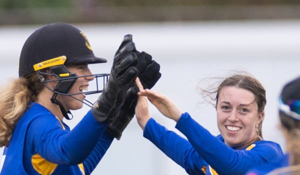 Mollie Adams and Eve O'Neill celebrate a wicket