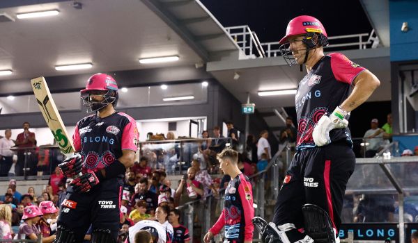 Daniel Hughes and Babar Azam await heading out to the crease