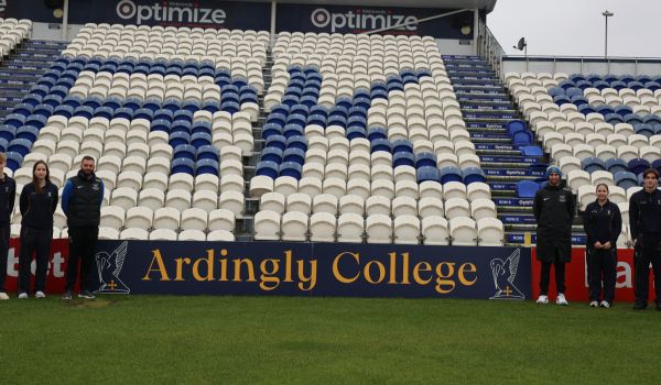 Pupils from Ardingly pose in front of the new advertising board with Sussex players at Hove