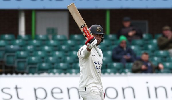 Tom Haines raises the bat as he passes 50