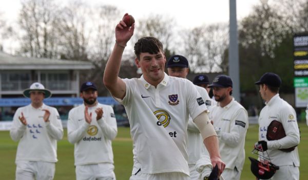 Crocombe raises the ball, acknowledging the applause for his five-fer.