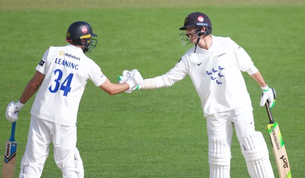 Leaning shakes hands with Hughes