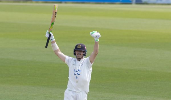 Daniel Hughes celebrates his century.